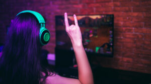 Computer games, playing place, young gamer playing video games with headphones.
